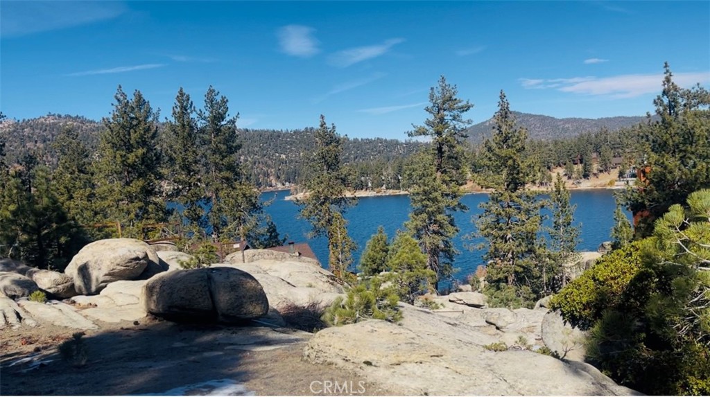 Build your dream home on this stunning and rare 13,600 sq. ft. lakeview lot. Nestled in a serene and picturesque location, this property features striking outcropping boulders that beautifully enhance the natural landscape. Enjoy breathtaking lake views that create an idyllic setting for relaxation and inspiration.
The sale includes approved building plans, with all permit fees paid and the survey completed—ready for immediate groundbreaking! The proposed residence spans approximately 3,000 sq. ft. and boasts a luxurious A-frame design with charming dormers, along with a lower-level basement. The architectural plans include a tall, attached entry roof and a breezeway roof seamlessly connecting to a spacious 750 sq. ft. detached garage.
Outdoor living is elevated with expansive exterior spaces, including decks, patios, and a breezeway, totaling an impressive 1,550 sq. ft.—perfect for entertaining or unwinding in nature. Designed with durability in mind, the steel frames at the grand entry and breezeway roofs ensure both stability and longevity.
Whether you're envisioning a peaceful family retreat or a lucrative Airbnb investment, this property offers a rare and exciting opportunity to bring your vision to life. Don't miss out on making this dream a reality!