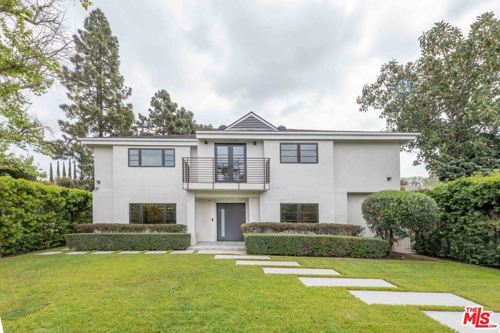 In a prime location in Hancock Park, a highly desirable and accessible neighborhood. Attentively rebuilt, remodeled and reimagined in 2018 by Sorensen Architects, it embodies sophistication and modern elegance. The dramatic two-story entry leads into a spacious great room and gourmet kitchen, featuring top-of-the-line appliances, including a Sub-Zero refrigerator, Wolf double oven and range, dual sinks, Caesarstone countertops, and a White Carrara Extra marble island. French white oak floors and skylights flood the space with natural light, creating a warm and inviting atmosphere. With 5 bedrooms (4 upstairs, 1 downstairs) and dual staircases, the layout strikes the perfect balance between functionality and luxury. The primary suite includes a custom walk-in closet and a spa-inspired bath, complete with Kallista sinks, a Rift white oak vanity, Italian Bianco Gioia marble, and Porcelanosa tile. This home has been thoughtfully updated with new plumbing, a new roof, LED lighting, Anderson E Series dual pane windows, dual tankless water heaters, and dual-zone HVAC with Nest thermostats, ensuring comfort and energy efficiency.