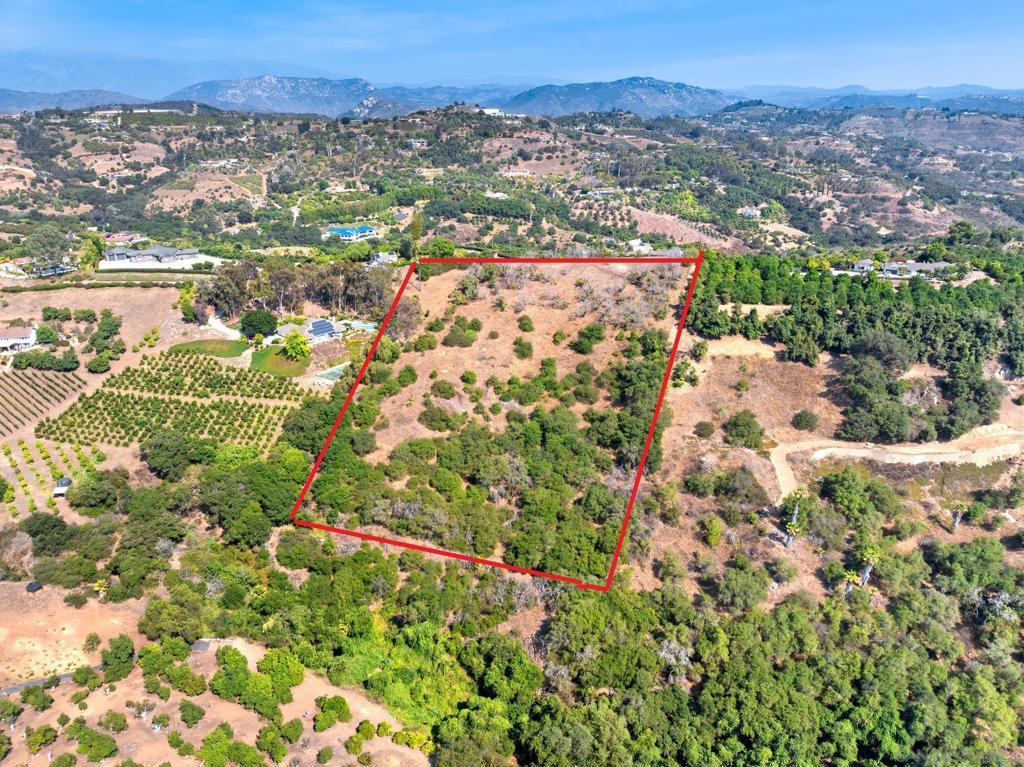 From a single vantage point, watch the sunrise over the Palomar Mountains to the east and the sunset to the west—a rare dual-view setting that few properties can offer. Situated on 6.74 acres of fully usable, fenced-in land in the heart of Fallbrook’s highly sought-after Gird Valley, this parcel combines the best of luxury living and rural charm. Ideal for a custom estate with space for agricultural pursuits—such as a boutique vineyard, hobby farm, or revitalized orchard—the property was once home to an avocado grove and still holds rich potential for a lifestyle-driven vision. Set against rolling hills and framed by exquisite sunsets, it enjoys cool ocean breezes all summer long and is surrounded by high-end custom homes. A graded, well-maintained private neighborhood road leads to the site, with water already on the property—ready for immediate development. Just minutes from Monserate Winery, Fallbrook Golf Club, and with easy access to both the 76 and 15 freeways, this location offers both tranquility and convenience. Less than 35 minutes from the Pacific Ocean and under an hour to San Diego, it’s the ideal place to unwind, recharge, and live your dream—whether that means a private retreat, sustainable homestead, or luxury estate with room to grow.