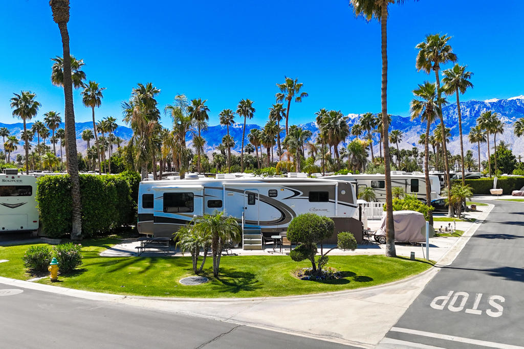 Discover luxury living in this lot/RV package featuring a beautifully landscaped corner lot with a large greenbelt to the side and mature ficus trees to the rear for added privacy. Adjacent to Satellite B for convenience. Outdoor Resorts Palm Springs is a Five Star RV Resort Community combining luxury with affordability. It is a guard gated resort that sits on 137 beautifully landscaped acres with 27 holes of executive golf. 10 tennis courts. 13 pickleball courts. 8 swimming pools. a full equipped fitness center. beauty salon/barber shop. full-service restaurant. convenience store. 2 club houses, activities, special events and so much more.