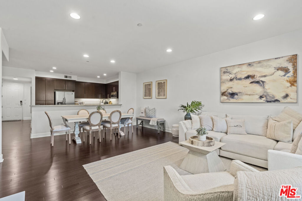 Experience the best of Toluca Lake living in this beautifully maintained condominium. With two spacious bedrooms and two full bathrooms, this home blends comfort and style in a way that's perfect for everyday living. The kitchen features stainless steel appliances, touchless water faucet, including a Bosch 800 dishwasher replaced in 2024, granite countertops, and modern cabinetry, along with a generous breakfast bar that's ideal for morning coffee or casual meals. The open-concept layout makes entertaining easy, with the dining area flowing into the inviting living room. Large living room windows maximize natural light, Rich hardwood floors and a fireplace, add warmth and character, making it a perfect space to unwind or host friends. Both bedrooms are well-sized with two triple closets, and the primary suite includes a large walk-in closet. For modern convenience, the property is equipped with a NEST thermostat and a Lockley Keyless Entry Smart Lock. Additional features include in-unit laundry, tandem parking with an EV charger, and secure building access. This newer-construction community has been well-cared-for and is move-in ready. Step outside and enjoy all that Toluca Lake has to offer. Outdoor enthusiasts will appreciate the proximity to Beeman Park, Valley Spring Park, Lakeside Golf Club, and hiking trails at Fryman Canyon, Runyon Canyon, Griffith Park, and the Hollywood Hills. Bikers will love the Chandler Bike Path and other nearby routes. This blend of suburban charm and urban convenience makes the property's location truly exceptional. With lush courtyard spaces and a prime location, this condo offers the perfect mix of comfort, convenience, and local charm.