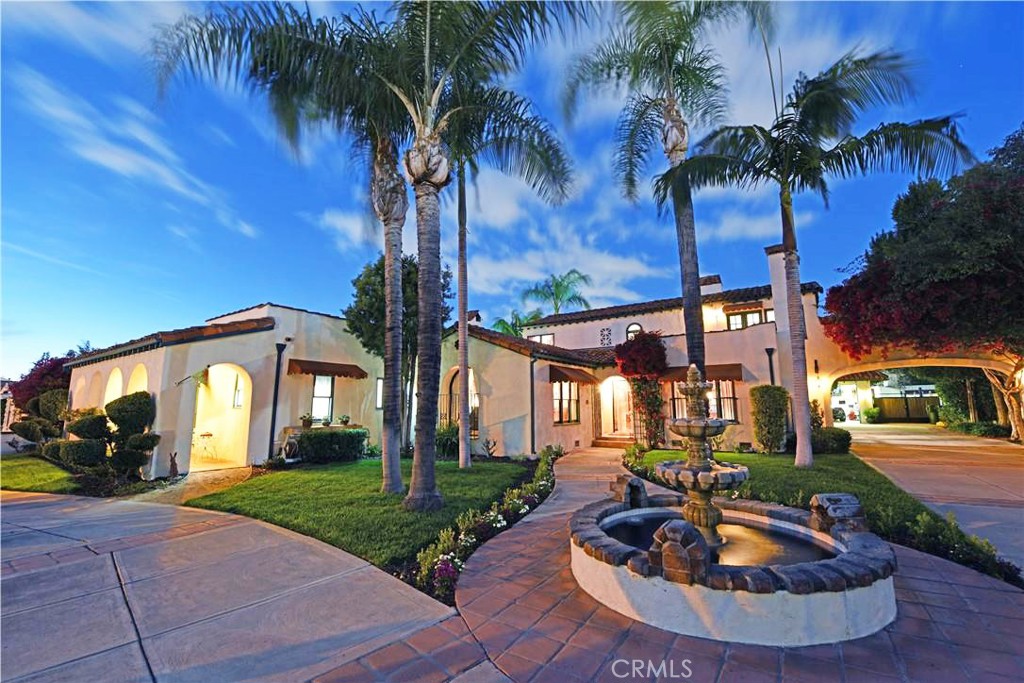 One of a Kind Mission Revival Architectural Estate! This spectacular property offers numerous detailed upgrades and amenities including: a spacious eat in kitchen with stainless appliances, tile counters & custom cabinets, large downstairs primary en suite with cozy seating by fireplace & French doors overlooking the pool, dual walk in closets, new primary bath tile flooring, classic high end flooring throughout including single plank wood & Saltillo tile flooring, library with fireplace, living room with fireplace & custom original built ins, large dining room with antique chandelier & French doors, 2 large charming upstairs bedrooms with original built in dressers, one with vanity, & other bedroom has terrace room with access to veranda with views over to CSUF, upstairs bathroom has new tile floor and shower plus has two original built ins, a downstairs built in office space with access to a temperature & humidity controlled below grade wine cellar with racks for over 100 bottles, inside private laundry room , coffered ceilings, custom awnings, numerous archways & arched windows, dual AC's with one being brand new & dual water heaters, security system, 6 car garage with space heater, air compressor, work bench, built ins plus behind garage workspace & 4 post car lift, backyard pool/spa with gorgeous new pebble tec finish, built in BBQ, automatic iron security gate, parkway landscaped with drought tolerant plants, multiple fountains, near century old delicious navel orange tree and all nearby award winning schools.