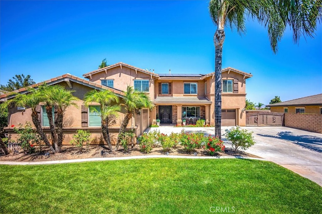 Welcome to your private retreat in the heart of the desirable Chase Ranch community! This expansive 6-bedroom, 4-bathroom home—with a dedicated office—offers the perfect blend of functionality and elevated style. From the moment you arrive, the custom steel double doors create a striking entrance that sets the tone for what’s inside. The main level features durable tile flooring and an open-concept layout designed for modern living. The kitchen is a chef’s delight with rich blue-gray granite countertops, stainless steel appliances, and a beautiful travertine backsplash that complements the custom fireplace surround in the adjacent living space. Designed for year-round entertaining, the backyard is a true showstopper. Splash into the resort-style pool, featuring a shallow, walk-in entry and a custom-designed grotto with a rockslide—perfect for both relaxation and recreation. Unwind beneath the gazebo or fire up the built-in BBQ at the tiki bar. With integrated surround sound speakers throughout the yard, simply connect via Bluetooth and let the good times roll. Adding to the home’s value and efficiency is a solar energy system, helping to keep utility costs low while keeping your comfort high. Ideally located in Chase Ranch, this home is just minutes from scenic trails, parks, shopping, and dining—including Citrus Park, Stagecoach Park, and The Shops at Dos Lagos. Experience space, style, and the ultimate in indoor-outdoor living—this is Southern California living at its best.