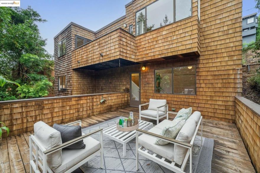 This peaceful North Berkeley Hills retreat offers light-filled living with freshly refinished hardwood floors, tall ceilings, and green views from almost every window. Step inside to find a welcoming living room, a bright dining area, a kitchen complete with pantry, and a handy half bath. Sip your morning coffee on the deck accessed through French doors. Down one level, all three bedrooms, including a primary suite with en-suite bath are thoughtfully located with laundry nearby. A dedicated office with both interior access and a separate entrance is on the third level providing privacy and flexibility for work or guests. Built in 1979 with modern systems and copper plumbing, the home combines reliability with comfort. Multiple decks, a sunny patio, and a secluded hot tub invite you to relax and enjoy the surrounding natural beauty. Just minutes from UC Berkeley, the Rose Garden, and neighborhood parks, as well as Berkeley’s shops and restaurants, this home offers the perfect balance of convenience and tranquil hillside living.