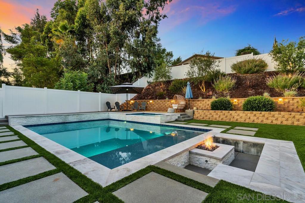 Welcome to this beautifully upgraded single-story home with your very own private backyard oasis, nestled in the heart of Poway. This 3 bed, 2 bath, 1,358 sq ft home blends thoughtful design with high-end finishes to create a space that is both functional and inviting. Inside, you’re greeted by an open-concept layout filled with natural light and soaring ceilings in the living room centered by a gas fireplace. Luxury vinyl flooring flows throughout, and the kitchen features marble countertops, a spacious island, and recessed lighting. Every upgrade has been meticulously planned for long-term comfort and style—from complete home re-plumbing, beautifully updated bathroom finishes, to a custom wine bar with built-in cabinetry—perfect for entertaining. Step outside into a truly resort-like backyard. Designed for both relaxation and entertaining, the space features a brand new solar-heated pool and spa with water features and a Pebble Tec bottom. A built-in gas fire pit offers a cozy gathering space and lush landscaping, a terraced and lighted hillside along with low-maintenance turf create a private retreat. White vinyl fencing and a full security camera system for added peace of mind. The backyard also includes an 8x10 finished "she" shed—with flooring, electrical, A/C, heating, windows, and blinds offers the ideal space for a home office, studio, or gym. Located in the highly sought after Poway Unified School District with easy access to shopping, dining, and freeways, this home is a rare opportunity to enjoy effortless indoor-outdoor living, all in a prime location.