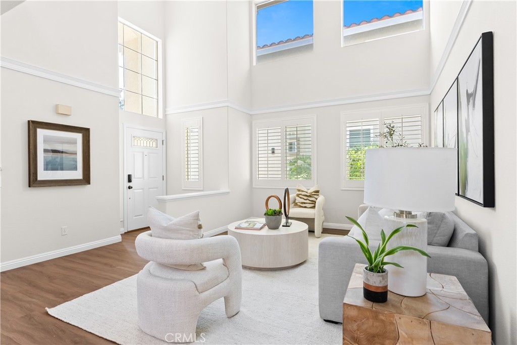 Welcome to this beautifully upgraded move-in ready home featuring paid off solar, PEX piping, EV charging, and the rare convenience of dual primary suites including one on the main floor. From the moment you step inside, you're greeted by soaring two story ceilings, abundant natural light, and a layout designed for both everyday comfort and effortless entertaining. The interior boasts a rich blend of hardwood and luxury vinyl flooring, complemented by plush carpet in the upstairs bedrooms. Thoughtful details like custom crown molding, plantation shutters, and designer paint tones create a warm and inviting atmosphere, while the brand new A/C system and ceiling fans throughout ensure year round comfort. The chef inspired kitchen features a custom backsplash and flows seamlessly into the open concept living and dining areas. French doors lead to a fully paved low maintenance backyard your private retreat complete with a built in fireplace and shaded gazebo, perfect for entertaining guests or enjoying cozy evenings at home. Upstairs, discover additional upgraded spaces including an office with wainscoting, a second primary suite, and generous storage. The two car garage is finished with epoxy flooring and a full driveway, offering both function and style. Every detail has been considered in this exceptional property from its energy saving features to its flexible floor plan and high end finishes. The entire interior of the home was also just recently painted. This is more than a home it’s a lifestyle upgrade. Schedule your showing today!