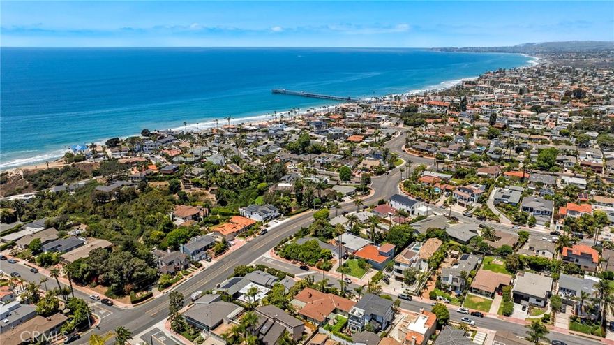 Welcome to a rare opportunity in the highly sought-after Southwest San Clemente community, mid-century, single-level home set on an expansive double-like lot in the desirable 200 block, just minutes from the iconic T-Street Beach, San Clemente Pier, and world-renowned surf breaks. This property boasts the largest lot on this side of the street, offering exceptional outdoor space, privacy, and future potential. Spanning 2,034 square feet, this thoughtfully designed 4-bedroom, 2-bath residence showcases a bright, functional layout filled with natural light. The remodeled kitchen features classic shaker cabinetry, sleek quartz countertops, luxury vinyl flooring, and a cozy eat-in breakfast nook, ideal for everyday dining and casual gatherings. The spacious living room centers around a warm fireplace, real wood floors, and oversized sliding doors and large windows create a seamless connection to the outdoors. The primary suite includes direct access to one of two backyards and a well-appointed en-suite bathroom with a walk-in shower, separate soaking tub, and tranquil garden views. True to its mid-century roots, the home embraces clean architectural lines and a harmonious integration with nature, enhanced by a beautifully landscaped wrap-around yard. Two covered patios provide ample space for outdoor dining, entertaining, or simply enjoying the coastal breeze. Additional highlights include a 2-car garage with direct entry, a spacious laundry room with built-in storage, a tankless water heater, and a whole-house water purification system. The oversized lot presents a rare investment opportunity to expand, build, or reimagine the property to suit your vision. This is more than a home, it’s a gateway to the quintessential Southern California and Southwest San Clemente lifestyle. Don’t miss your chance to own a piece of coastal paradise in one of San Clemente’s most desirable neighborhoods of Tstreet.