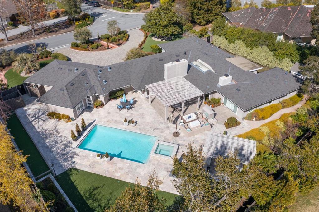 Elegance and quality craftsmanship radiate throughout this thoughtfully remodeled ranch style home sighted on a level 23,244 sq. foot lot in the highly coveted Country Club neighborhood. Paved, circular driveway with 3 car garage. The idyllic open floor plan includes 5 bedrooms, 4 bathrooms with a spacious and voluminous Primary Suite. The redesigned public areas are open and bright, and the newly remodeled gourmet kitchen is fitted with top of the line Hestan appliances, 9 foot island with waterfall edge and seating for 4 is ready to please when entertaining family and friends. Stepping outside you will revel at the resort like professionally landscaped grounds. The masterful use of hard surfaces seamlessly wrapping around the sparkling pool, fireplace with pergola, bocce ball court, she shed/artist studio, outdoor kitchen equipped with top-of-the-line Viking Grill & appliances including a Lynx pizza oven all designed to provide the ultimate in entertaining spaces & outdoor enjoyment.