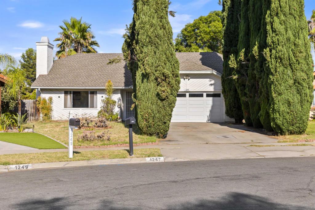 Located in a quiet Escondido neighborhood, 1247 Armstrong Circle is a charming single-story home set on a spacious 0.21-acre corner lot with no HOA. Built in 1980, this approximately 1,653-square-foot residence offers four bedrooms and two full bathrooms, all conveniently situated on one level. The interior features a welcoming living room with a cozy fireplace, a separate family room, and a kitchen that opens into the main living spaces for easy flow and connection. Outdoors, the backyard is a true highlight, with mature lemon, orange, and pomegranate trees, grapevines, and an inviting patio perfect for relaxing or entertaining. A two-car attached garage adds to the home’s practicality, while the surrounding community offers sidewalks, streetlights, and proximity to schools, shopping, and commuter routes. With its combination of comfort, space, and charm, this property is ready for its next chapter.