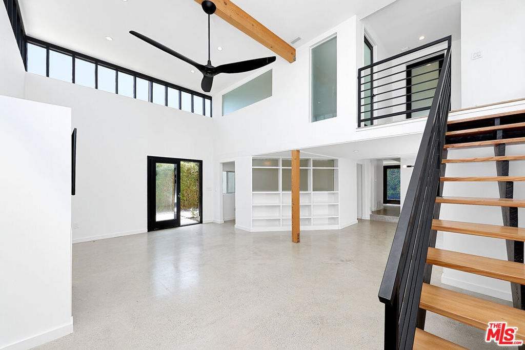 Originally conceived as the personal studio of award-winning architect Frederick Fisher AIA, this striking modern residence channels the spirit of Venice Beach creativity through bold geometry natural light and intentional simplicity. Nestled just one block east of Abbot Kinney, the 3-bedroom 3-bath home offers an inspiring blend of artistic heritage and functional elegance. Step inside to find dramatic double-height ceilings in the main living area framed by clerestory windows that flood the space with light while preserving tranquility and privacy. Clean lines, polished concrete floors, and wide plank oak flooring create a gallery-like atmosphere, perfect for both everyday living and creative inspiration. The chef's kitchen features a full suite of stainless steel Bertazzoni appliances and seamlessly integrates with the open concept layout ideal for entertaining or a quiet night in. The expansive primary suite boasts a spa like bath with a large soaking tub and glass shower offering a true retreat experience. Two outdoor living areas, lush with eco-conscious permeable landscaping and anchored by a custom gas fire pit, extend the Zen-like ambience beyond the walls. A rare find in Venice the property also includes garage parking for two cars with gated access. With its architectural legacy, exceptional layout, and proximity to the best of Abbot Kinney, this residence is more than a home, it's a statement.