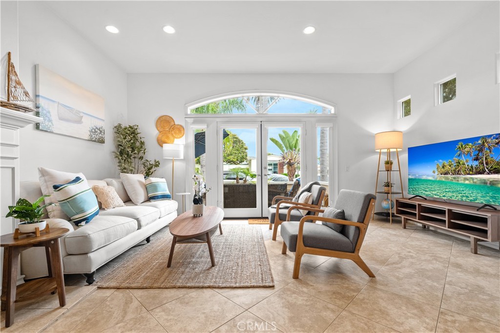 Just minutes walk to Main Street downtown Huntington Beach and the sand! Perfectly situated between the beach and world class amenities just beyond the front door is this coastal retreat newer built in 2000, 3 bedrooms, 3.5 bathrooms and a living of 2,387Sqft that serves well as vacation rental or a permanent residence near the ocean, this property has it all. Step through charming French doors into a bright open floor plan featuring a cozy living room with fireplace, inviting dining area and a chef-worthy kitchen with upgraded quartz countertops and new stainless steel Bosch cooktop. The first floor also includes a spacious family room, ideal for entertaining. Upstairs, the luxurious primary suite boasts a private balcony, spa-inspired bath, and walk-in closet. Two additional ensuite bedrooms and a den provide flexibility for guests or a home office, plus the convenience of an upstairs laundry room. Head up to the rooftop deck to enjoy ocean breezes, sunsets, and 4th of July fireworks with views that capture the best of Huntington Beach living. Additional highlights include attached two-car garage, large driveway that can fit additional three cars, a new HVAC system, tankless water heater, and outdoor shower — perfect after a day at the beach. Currently operating as a successful short-term vacation rental and got highly rated on multiple platforms. Don't miss out on the opportunity to make this your forever home and experience all that downtown Huntington Beach has to offer. Live, host, or invest — your beachside lifestyle starts here!