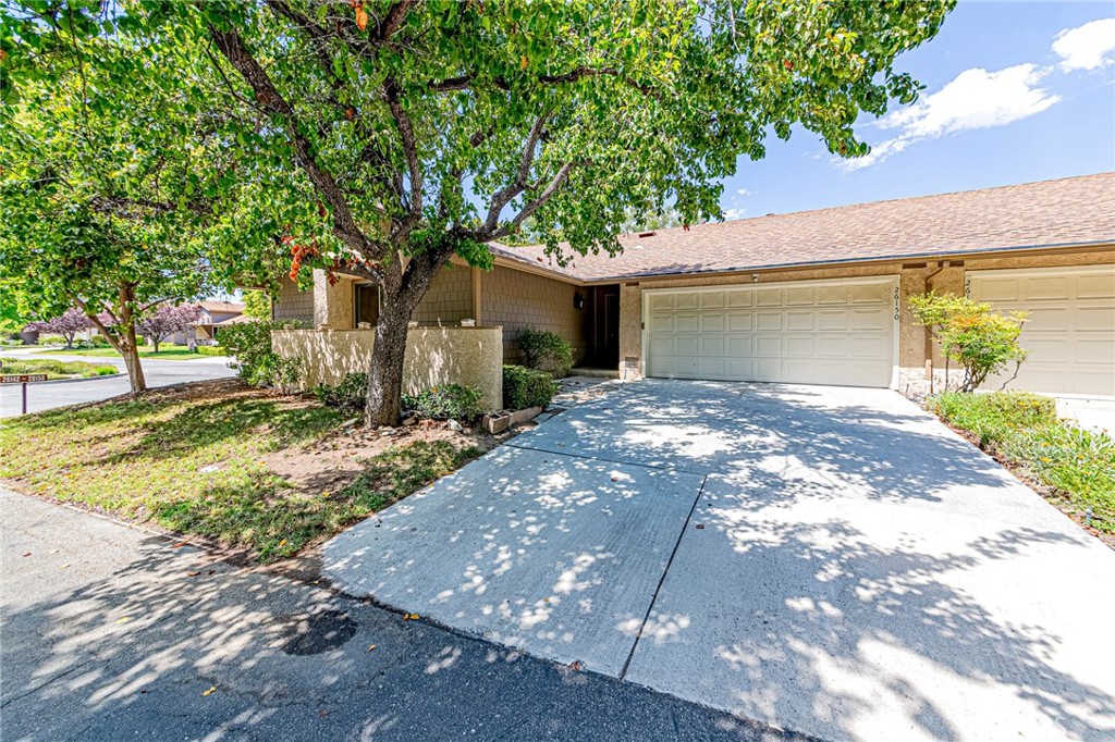 Stunning Single-Story Home in Scenic Hills with Panoramic Views. Welcome to this exceptional home nestled within the serene, gated Scenic Hills community of highly sought-after Santa Clarita. Perfectly situated to offer both discreet privacy and convenient access to Golden Valley shopping centers, restaurants, and freeways, this residence combines the best of tranquil suburban living and urban convenience. This rare single-story home is located on one of the community’s premier lots and features an inviting open floor plan filled with natural light, hardwood flooring throughout, recessed lighting, and elegant crown molding. Step inside to a spacious living room with a cozy fireplace and large windows showcasing breathtaking views. Sliding glass doors lead to a private backyard with a wooden patio, perfect for relaxing or entertaining while enjoying both daytime scenery and night views. The kitchen offers a warm, modern aesthetic, ideal for casual meals and intimate gatherings. The generously sized primary suite offers a peaceful retreat, while both full bathrooms have been tastefully remodeled with stylish finishes. Additional highlights include a side-by-side two-car attached garage with direct access, a long driveway, and ample guest parking nearby. Enjoy the extensive Scenic Hills community amenities, including, 9-hole private golf course, Tennis courts, Pool, spa, Gym, and clubhouse. The HOA covers exterior maintenance, including the roof, exterior paint, gutters, front yard landscaping, and earthquake insurance—all with no Mello-Roos tax. This is a rare opportunity to own a beautifully upgraded home in a prime location. Truly a must-see. Don’t wait, this gem won’t last!