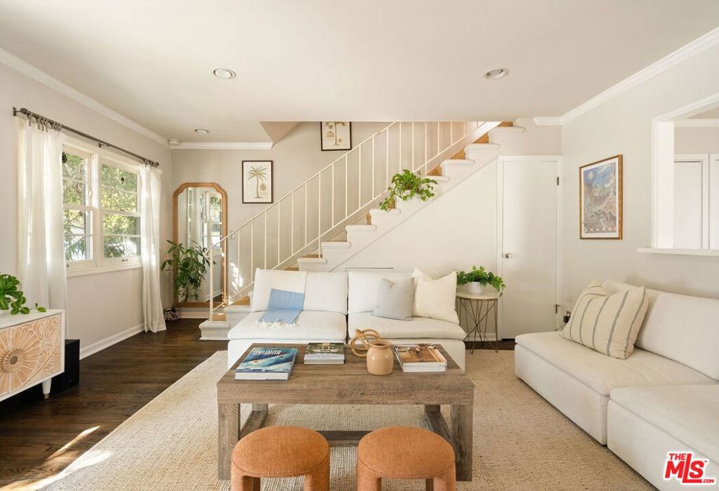 Enjoy the perfect blend of beach cottage charm and elevated, modern ease just four blocks from the ocean. This bright and breezy Ocean Park townhome feels like your own private retreat. An end-unit, with only one shared wall and its own private entrance, offers a sense of seclusion in a prime location. The main level has an easy flow between the living area and kitchen while a standout feature is the spacious private outdoor patio, complete with built-in seating, a gas fire pit, outdoor shower and redwood privacy fencing, perfect for outdoor dining or evening hangouts.Upstairs, two tranquil bedrooms with an abundance of natural light share a well-appointed bathroom. Additional highlights include wood floors throughout, central air, in-unit laundry, plenty of storage space, a private attic, two tandem parking spots and a maturing lemon tree at the entrance. Located in a well-kept four-unit complex with low monthly fees that cover earthquake insurance, this laid-back home is in an unbeatable westside spot just around the corner from the sand, a variety of highly rated restaurants, coffee spots and shops on Main Street, Rose Avenue and Downtown Santa Monica.