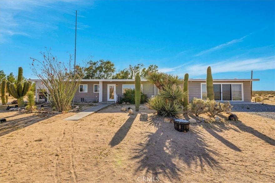 Discover the perfect blend of mid-century style and modern desert living in this beautifully updated 3-bedroom, 2-bath retreat. Set in a serene and scenic location near Goat Mountain and the iconic Integratron, this stylish home offers comfort, character, and incredible natural surroundings.



Inside, you'll find a stunning kitchen featuring butcherblock countertops, custom cabinetry, and newer top-of-the-line appliances—ideal for both everyday living and entertaining. White epoxy floors flow seamlessly throughout the home, complemented by large dual-pane picture windows that flood the space with natural light and frame the surrounding desert landscape.



The nicely appointed primary suite offers a peaceful escape with beautifully finished natural wood ceilings, a luxurious spa-like ensuite bath, and breathtaking sliding glass doors that open to sweeping desert views. Two additional guest bedrooms share an updated full bathroom, offering comfort and privacy for visitors.



Thoughtfully furnished and tastefully decorated, many of the furnishings may stay—making this an effortless transition into your new space!



Step outside to your own 5 acre desert oasis, of which 2.5 acres are fully fenced with a convenient automatic gate,  complete with a relaxing hot tub and a mature cactus garden. The West side of the home is cooled by the shady tamarisk trees. while several mature pine trees offer privacy on the South. Whether you're soaking in the spa, lounging under the stars, or enjoying the peaceful surroundings, this home invites you to slow down and savor desert life. 



Tucked away and full of potential, the cozy shed offers the perfect escape for work or creativity. With electricity already in place, it’s move-in ready as a quiet home office, inspiring art studio, writing retreat, or hobby space. Enjoy the peace and privacy you need to focus, all just steps from home. Whether you're painting, Zooming, or simply daydreaming, this little gem is ready to support your next big idea.



Whether you're a first-time buyer, downsizing, or seeking a turn-key investment, this property checks all the boxes. Even better, the owner is open to seller financing, offering flexible terms to help make homeownership more accessible.



Located just minutes from Joshua Tree National Park, Pappy & Harriet’s, La Copine, and all the best of the Morongo Basin, this home is a rare find—ideal as a full-time residence, weekend getaway, or stylish vacation rental.