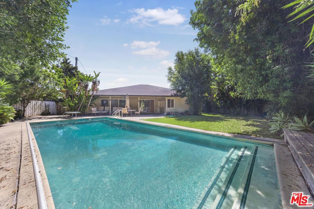 A remodeled, single-story, Ranch style home in the desirable Country Club Estates section of Cheviot Hills, this 4 bedroom/3 bath plus den (possible 5th bedroom) is an absolute oasis. The home exudes luxury California living at its best. Situated on a massive 11,227 sq ft. lot, the 2478 sq ft mid-century home boasts a huge, grassy backyard surrounded by tall privacy trees and hedges, anchored by an oversized swimming pool with automatic cover. Each of the bedrooms are extraordinarily generous in size. There is a vast Living room with fireplace and cozier den, both social spaces open to the backyard through huge sliding glass doors. The updated kitchen provides decorative backsplash, stainless appliances, great prep space and adjoining breakfast nook. Additional amenities include: big laundry room, two-car garage, excellent storage space and enviable location. Your family can move right in to this fabulous home. Come visit today!