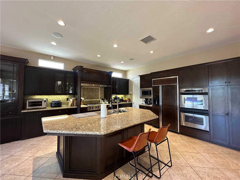 Exquisite Upgraded Estate on a Prime Cul-de-Sac Location in the Prestigious Gated Neighborhood of Canyon View Estates* Solar* *Gourmet Kitchen w/Large Island, Huge Breakfast Nook & Butler s Pantry *Upgrades include Granite Counters + Full Granite Backsplash, Espresso Cabinetry & Stainless Steel Appliances *Formal Dining Room *Spacious Great Room w/Built-In Media Center + Romantic Fireplace *Beautifully Landscaped Backyard w/Covered Patio, Tropical Landscaping, Tranquil Fountain & Peaceful Views *Luxurious Master Suite w/Covered Viewing Balcony + Huge Walk-In Closet *Lavish Master Bathroom w/Dual Vanities, Jacuzzi Tub & Shower Stall *Convenient Upstairs Laundry Room *3 Secondary Bedrooms (1 on the Main floor) *Convenient Loft *3 Upgraded Bathrooms *Stunning Upgrades Thru-out! *Espresso Cabinetry *Granite Counters *Recessed Lighting *2-Tone Paint *Iron Side-Gate *Upgraded Tile Flooring w/Granite Accents *Speaker System thru Kitchen, Master, & Loft *Truly an Amazing Home. *Proxy Floor in Garage * Re-Piped! * New Water Softener. Come see it today before its gone!