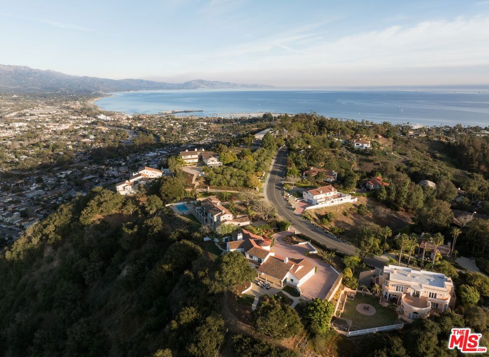 Make your Santa Barbara dreams come true in this spectacular view estate! From its serene location on the Upper Mesa's ''TV Hill'' enclave, this one-of-a-kind property showcases magnificent mountain panoramas by day, sparkling cityscapes by night, and generous peeks of the ocean. Located on nearly 2 acres in a rarely available neighborhood, the home is just minutes from downtown, Shoreline Park, and the harbor. The 4,600+ sqft residence is comfortable and spacious, offering pause-worthy vistas from nearly every room.Step through the front entry doors and be inspired by breathtaking views throughout the home's open & airy floor plan, which features vaulted ceilings, beautiful archways, and abundant natural light. The focal point of the main living area is a jaw-dropping mountain-view window, complemented by the room's open-beam woodwork, a stately fireplace, built-in shelving, and convenient access to outdoor patios and walkways. The light-&-bright kitchen offers abundant counter space and storage, a sunny breakfast nook, and plenty of room to entertain while preparing a gourmet meal. The adjacent family room provides the perfect space to relax by the fireplace or easily step outside to enjoy a front sunroom or the expansive back patio.The secluded primary suite is located on the main level and features vaulted ceilings, a fireplace, a private patio, dual bathroom vanities, a walk-in closet, and an adjacent office with ocean views. Ascend the romantic spiral stairway to find 2 additional bedrooms, each with balcony access and more stunning mountain views. A first-floor laundry room and an attached 3-car garage complete the home's generous floor plan.Offering a truly rare and awe-inspiring vantage point from which to enjoy Santa Barbara, this beautiful property is ready for its next owners to make this unique oasis their home sweet home.
