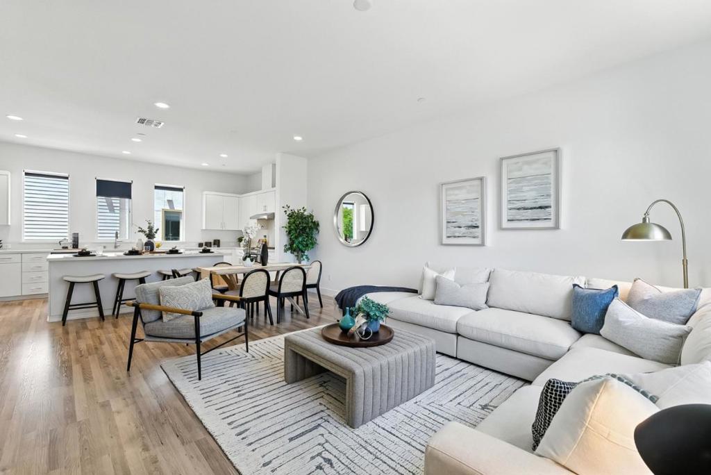 A Contemporary 2-bedroom, 3-bath townhouse-style perfectly situated in the heart of downtown! This tri-level home exudes modern elegance, featuring an expansive open-concept living and dining area with soaring 10-foot ceilings and wide-plank luxury flooring throughout. Natural light pours in through multiple windows, highlighting the stunning entertainers kitchencomplete with crisp white cabinetry, quartz countertops, a spacious center island, and sleek stainless steel appliances. Upstairs, both generously sized bedroom suites offer ensuite baths and privacy, ideal for dual owners or guests. Enjoy high-end finishes, updated bathrooms, walk-in closets, and energy-efficient dual-pane windows for year-round comfort. A show-stopping rooftop deck crowns this home, offering a private outdoor oasis to soak in sweeping views of the Dublin Hillsperfect for sunrises with your morning coffee or colorful evening skies. Additional features include a freshly painted interior, new carpet, attached two-car garage with EV charger, and access to an award-winning BIA community featuring striking modern architecture and creative landscaping. Just minutes to BART, 580/680, top-rated parks, shops, and Dublins most charming playgroundsthis home brings elevated East Bay living to your doorstep.
