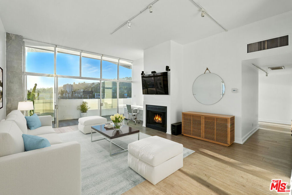 PENTHOUSE. VIEWS. VIBES. LIVE ABOVE IT ALL IN THIS DESIGNER-DONE WEST HOLLYWOOD PENTHOUSE WITH BREATHTAKING JETLINER VIEWS FROM EVERY ROOM. Walls of glass, soaring ceilings, and an expansive wraparound balcony create the ultimate indoor-outdoor lifestyle perfect for sunrise coffee or sunset cocktails. This corner showpiece features hardwood floors, a sleek open layout, and a cozy fireplace for intimate nights in. The serene primary suite feels like a luxe retreat, floating high above the city. Enjoy five-star amenities: 24-hour doorman and valet, concierge, heated pool, spa, gym, sauna, recreation room, and a private dog park. Located minute from Sunset Plaza, Equinox, and world-class dining and nightlife. Now available for lease, this rare opportunity won't last. Private showings by appointment. Refer to showing remarks.