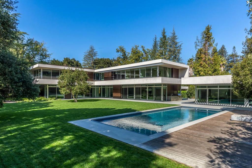 Engineering & architectural masterpiece in the heart of Atherton. Built by Lencioni Construction with architecture by Swatt Miers. A world-class destination for luxurious living as well as corporate and/or professional events with pool-side guest house. Sleek interiors with entire walls of glass, heated floors in polished concrete and white oak without baseboards, exotic cabinetry, & hidden hinges on interior doors. 3 levels with solar-powered electricity. Stunning open kitchen and family room, flex room for studying or hobbies, executive office, plus tremendous recreation/media room, and large fitness center with steam room & sauna. 6 bedrooms include 5 upstairs and 1 on lower level + guest house with 1 bedroom, 1 bath & full kitchen. Over 11,000 total square feet. Pool & spa, fire pit, barbecue center, heated terraces, sport court, playground. Detached 3-car garage with EV charging. Midway between San Francisco & Silicon Valley. Excellent Menlo Park schools.