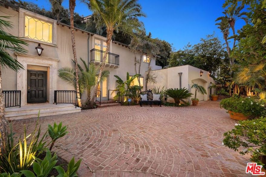 On prestigious Stone Canyon in prime lower Bel-Air, this private and gated 4 bed, 5 bath 5,000SF+ beautifully updated Traditional Villa offers an inviting indoor-outdoor California lifestyle. A wall of glass doors opens the formal dining area to the lush and private backyard with soaring mature trees, a large heated pool, pizza oven, alfresco dining and several cozy sitting areas perfect for open-air entertaining. The well-designed floor plan has a lovely flow with 3 spacious bedrooms on the upper-level and one bed down, all ensuite with generous closet space. The property offers an abundance of outdoor living areas, including two spacious, private patios accessed from the upper level master and secondary bedroom. An abundance of natural light fills the cheerful and bright home. Welcomed by a grand two-story entry foyer and an inviting, lush private entry courtyard, this stylish home is a must see.