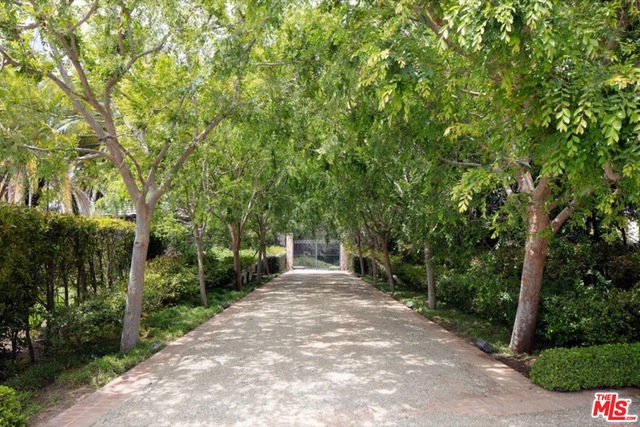 An incredible Brentwood Estate situated on 1.6 acres of park-like grounds, classic Wallace Neff architecture that's beautifully designed with impeccable style and taste. Approached by a gated tree-lined private driveway, the main house features approx. 9,000 sf including a stunning living room, dining room, and family room, gourmet kitchen, all light bright and open with vaulted wood beamed ceilings, gorgeous hardwood floors and French doors throughout. A stunning master suite with separate his & hers baths/closets, plus 3 full bedroom suites & maids. There's an additional separate 3,000 sf guest house with professional screening room. The most spectacular grounds in Brentwood Park, featuring gorgeous lawns, a stunning swimmer's pool with pool house, championship tennis court, fountains, walkways and total seclusion. Shown to pre-qualified clients only.