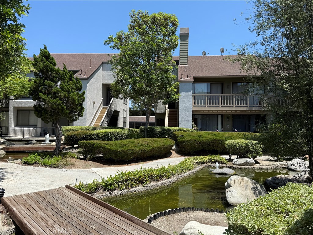 Tucked away in a peaceful, gated community surrounded by tranquil streams and picturesque walkways, this pet-friendly complex offers a resort-like atmosphere with lush landscaping, two sparkling pools, relaxing spas, and a charming park area.
Located on the upper level, this unit features an impressive open-concept floor plan and a beautifully updated kitchen—ideal for both everyday living and entertaining. Enjoy brand-new flooring throughout and tastefully remodeled bathrooms that add a modern touch.
Soaring vaulted ceilings enhance the bright, airy feel of the home. Step out onto the spacious balcony off the dining area to unwind and take in the soothing sounds of the water feature after a long day.
Additional highlights include in-unit laundry with your very own stackable washer and dryer, a generously sized primary suite with its own bathroom and walk-in closet, and a convenient attic space—perfect for storing seasonal items like holiday décor.
Don’t miss this opportunity to own a move-in-ready home in one of the area's most tranquil and well-kept communities!