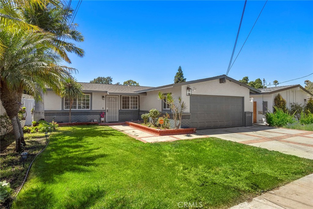 This beautifully updated Costa Mesa home offers the perfect blend of entertaining space and cozy family living. The single-level layout features 3 bedrooms and 2 bathrooms with an open floor plan designed for comfortable living. The spacious living room flows into the dining area and gourmet kitchen. The remodeled kitchen has granite countertops with gray-toned tile backsplash, a granite breakfast counter, stainless steel refrigerator, vent hood and ample cabinetry. The primary suite includes a remodeled bathroom with a step-in shower. Two secondary bedrooms, each with ceiling fans, share a full bath with modern finishes. Newer windows fill the home with natural light, making all the rooms bright and airy. Additional upgrades include luxury vinyl flooring, new paint throughout and a neutral color palette. Enjoy indoor/outdoor living with a covered patio overlooking a spacious backyard – ideal for gardening, a kids play area or future parties. Conveniently located near the 55 freeway, Orange Coast College, the Fairgrounds and Newport Beach. Whether you’re working from home, starting a family or “down sizing”, this move-in-ready home is a must see!!