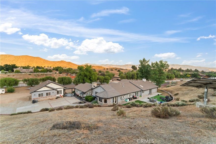 Significant PRICE IMPROVEMENT & Exclusive BUYER INCENTIVES! This Agua Dulce Single-story Estate has OUTSTANDING RENTAL POTENTIAL. Private Guest Quarters with a Separate Entrance & Parking, a Spacious Living Room open to a well-appointed Kitchen, a Separate Bed/Bath, & extra Storage throughout. 

Step through the Elegant leaded glass doors leading to an Expansive Great Room that unites the Dining & Living areas with a Bedroom upon entering. Ideal for entertaining on any scale. Custom hallway cabinetries maximizes storage & organization, blending both function and refined design.

The Ultra-luxurious Primary Suite, complete with a Dramatic DBLE-Sided Fireplace, a Private Office Nook, Entrance to Private Backyard & A Spa-Inspired Bathroom Featuring exquisite Granite Countertops, Custom Cabinetry, a Freestanding Soaking Tub, Dual Sinks, Skylight, & Beautifully Tiled Shower crafting a true haven of comfort & Elegance. 3 Additional Bedrooms are enhanced by 2 updated Bathrooms (including a convenient Jack & Jill layout). The dedicated Laundry Room is equipped with abundant Linen & Supply Storage for daily living.

Gourmet Chefs & Entertainers alike will be captivated by the Exceptional Kitchen Highlighted by Antique-Style Custom Cabinetry, Granite Countertops, a Central Island with Breakfast Bar Professional-grade Viking Appliances, Double Ovens, a Premium Sub-Zero Refrigerator & Freezer, & a Generous Walk-in Pantry. The bright Breakfast Nook opens through elegant French doors to the Outdoor Patio, seamlessly merging indoor and outdoor living. Vaulted ceilings, a striking Fireplace, & Family Room creates a warm & inviting atmosphere, perfect for relaxing or hosting gatherings. The Generous 800 sq. ft. flex Space presents Endless Opportunities ENVISION A Workshop, Private Gym, Creative Studio, or Even a Converted Living Suite for EXTRA INCOME. Ample parking & Storage are ensured with an attached 2 Car garage plus a 1-car garage with ADDITIONAL HUGE STORAGE AREA.

Enjoy Premium Amenities Outdoors, including a Lighted Tennis Court (Adaptable for Barn, Horse Corrals, Pickleball, Pool, our more. Fully landscaped grounds, water well, solar panels, vinyl fencing, and RV parking w/clean outs. Every aspect reflects this properties style. For UPGRADES & AMENITIES, See the Supplements Tab &  Virtual Tour. Solar payments are low about $245 monthly, with few years remaining. Buyers should verify all property details. Contact Agent for DETAILED Info on BUYER INCENTIVES.