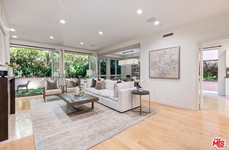 Serene single-level luxury condo in Prime Beverly Hills with a RARELY-FOUND apprx 525 sqft 2-sided garden patios!  Ideal for pet owners and those wanting a pretty yard for backyard space. Discover indoor-outdoor living at its best in this pristine 1719 sqft unit at the prestigious Almont Plaza. Ideally situated on a quiet, tree-lined street just north of Wilshire, this beautifully updated 2-bedroom, 2.5-bath condo feels like a private home complete with lush wraparound garden patios that create a tranquil retreat in the heart of the city. Located in a secure building, this rare first-floor corner unit offers complete privacy and a seamless flow for relaxed living and elegant entertaining. The expansive layout features a formal double-door entry, gracious foyer, and large living room with fireplace, custom built-ins, bar and walls of glass that bring the gardens in. The oversized formal dining room sets the stage for memorable gatherings. A bright, airy kitchen opens to the patio and is outfitted with top-tier appliances including a Sub-Zero fridge, white cabinetry, a spacious breakfast area, and side-by-side laundry. Designer finishes, wood floors, and oversized windows add sophistication throughout. The generous primary suite boasts a remodeled spa-like bath and an oversized walk-in closet. The second bedroom is equally spacious with a private ensuite bath, plus there's a beautiful powder room for guests. Additional highlights include a full security system, 2-car side-by-side parking in a gated secured garage, and access to luxurious building amenities: a stylish lobby, gym, sundeck, and meeting room. Water and EQ insurance included in HOA dues. Walk to restaurants and enjoy the best of the Beverly Hills lifestyle, renowned shopping, entertainment, Beverly Hills school district, police and fire.  Easy to show - This rare garden gem won't last!