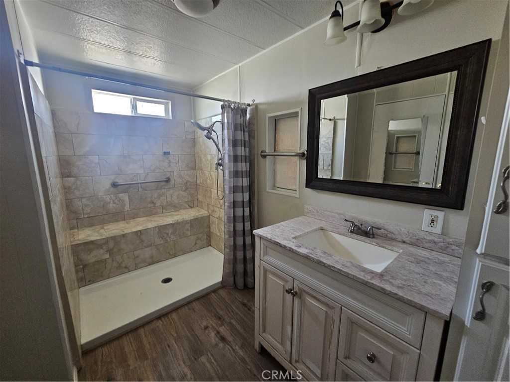 BEAUTIFUL UPGRADES in this charming, spacious 2 bedroom/1.75 bath home located in one of San Jacinto's nicest +55 communities! All NEW paint inside and out, NEW laminate flooring throughout, NEW Primary bathroom with H-U-G-E walk-in tile shower, NEW lavy, sink and fixtures, separate dressing area and large walk-in closet. Laundry hook-ups inside, large bedrooms, dining room and ample sized living room. (Ser# A/B4949). This one is a "MUST SEE" before you buy anything else!