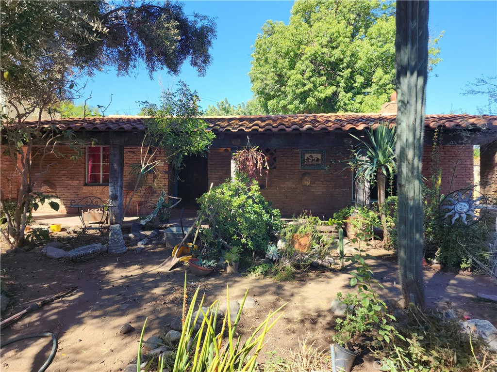 Here's your chance to own a piece of Riverside's History in the Colony Heights area of Redwood Dr. near Fairmount Park. This Spanish Colonial Revival named La Camarita, built by legendary builder Harry Marsh for retired druggist Philip Banks who once owned a drug store at the Historic Mission Inn and his wife Esther Rubidoux of the Rubidoux family. This outstanding Spanish Colonial architecture is a long, single story dwelling with a low gable and red tile roof representing California's historic hacienda period. The roof expands over a veranda that extends the length of the home's front with huge exposed rafters under the projected eaves and throughout the home. Tiles collected by Mr. Banks from around the world were incorporated into the wall and brickwork around the house. The garden contains his historical treasures such as an Olive Tree planted by Pioneer Juan Bandini in 1883, a Fig Tree by Spanish Land Grantee Louis Rubidoux in 1848, the first specimen of the Shamel Ash Tree imported from Mexico by Riverside horticulturist Archibald Shamel, the largest Sapote Tree in Riverside, the city's most spectacular Pindo Palm, and accompanied by many fountains and plaques throughout. Most notable is the bell copied from the original bell at Agua Mansa that's marked El Camino Real. The original has been stolen which adds value to the Banks copy. The main residence was built in 1933 and features 2Br's, 1Ba, 1715sqft as per assessor, Living room with fireplace, Kitchen, formal dining room, an enclosed porch addition, and utility room. The detached secondary building is 687sqft built in 1942 as per assessor, consists of 1Br, 1ba, and a Kitchen downstairs and an additional bedroom upstairs with access from the exterior. The third building is an attached garage 360sqft built in 1942 as per assessor. For the 2nd time in 92 years this home is available and can be yours along with historic artifacts sprinkled throughout the properties landscaping that represents the history of Riverside. This information is deemed reliable but not guaranteed. Buyer and buyers agent to do their own due diligence