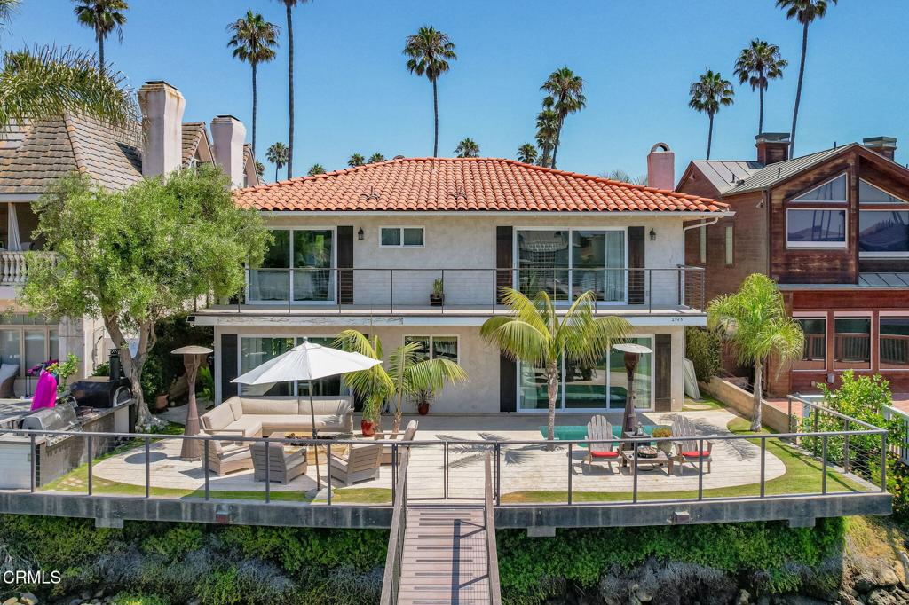 The Ventura Keys is a destination beach community located along a series of man-made saltwater canals in Ventura. Over 300 on water properties have private boat docks for direct access to the water and a desirable waterfront lifestyle.2965 Surfrider Ave is at the end of the street offering excellent access to the large open canal, ocean and Marina/ Harbor. Another consideration is Surfrider connects with Reef and Sailor for an 'island' therefore no pass through traffic creating a quiet, peaceful street. This 2930 sq. foot property flows beautifully from the calm inviting entry, to the kitchen / great room to the stunning patio with views of the water, access to private dock and unground spa. Entertaining is easy with a built in BBQ along with a real pizza oven! The main level also has a large living room with gas fireplace for those cool foggy days. A guest bedroom is also on the main level ~ a nice feature for guests and family without stairs involved. The upper level offers a large primary suite with a large slider door to the balcony for morning coffee and exceptional views. Attached is a primary bath, separate shower/commode and plenty of closet space. In addition, there are also two other bedrooms upstairs and a large bathroom with plenty of storage. Laundry is on the main level and garage is stocked full of bikes, surfboards, games and beach chairs. 2965 Surfrider is an exceptional opportunity to have a move in ready property for friends and family and embrace the beach living. Also included with this property is a complete set of City approved architectural plans designed by Coronado Design Group for potential remodel if desired. This is THE destination and THE location ~and rare opportunity this close to the main channel. Don't miss it!! Call now.