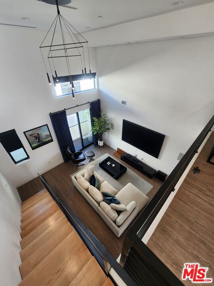 Luxury 3-Story Modern Townhome | Designer Furnishings | 3 Bed + 3.5 Bath | Smart Home | Loft + Views | North Hollywood. Furnished (Unfurnished option available) Experience elevated living in this stunning new construction 3-story townhome featuring soaring ceilings, dramatic architecture, and high-end finishes throughout. Located in a modern private community in North Hollywood, this home is perfectly designed for comfort, style, and functionality. PROPERTY HIGHLIGHTS 3 Bedrooms | 3.5 Bathrooms. One bedroom is fully outfitted as a private home gym complete with equipment and dual mounted TVs. Spectacular Double-Height Living Room Flooded with natural light, this designer living room features: 20+ ft ceilings. A striking modern floating staircase. Oversized windows. Chic curated furniture. Mounted smart TV with sound system. Sliding door to private balcony. Loft Level with Balcony & Views. A versatile loft overlooking the living room perfect for an office, studio, or lounge with access to a view balcony. GOURMET KITCHEN A chef-inspired kitchen showcasing:Quartz waterfall island with bar seating. High-end stainless steel appliances. Custom modern wood cabinetry. Statement geometric backsplash. Under-cabinet lighting. Walk-in pantryOpen layout ideal for entertaining. LUXE BATHROOMS Spa-like bathrooms feature: Dual vanities. Matte black fixtures. Oversized mirrors Walk-in glass showers. Sleek hex-tile flooring. SMART HOME & SECURITY, Brilliant Smart Home System Ring cameras + full alarm system. Keyless entry. Smart TVs included. EV charger in the garage. ADDITIONAL FEATURES 2-car attached garage with direct entry Full-size washer/dryer Designer furniture included (optional removal) New construction with premium finishes on every floor Centrally located near NoHo Arts District, studios, freeways, dining, and entertainment. This townhome offers a rare mix of luxury, technology, and architectural style perfect for anyone seeking a modern living experience in North Hollywood. Available now at $4,799/month furnished. (Unfurnished option available.)