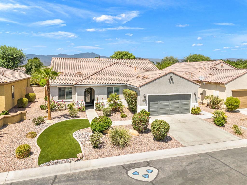 Prepare to be wowed! This is truly one of the most spectacular, extensively upgraded homes you'll find in all of Sun City Shadow Hills. This coveted Merida floor plan boasts three bedrooms, a spacious den, two baths, and nearly 2,400 square feet of pure luxury--meticulously remodeled with the finest materials and designer touches at every turn. From the moment you step inside, you're welcomed by the gleam of elegant custom Italian tile flowing effortlessly throughout the living areas. The formal dining room, large enough to host the entire family for holidays and celebrations, sets the stage for the warmth and sophistication that fill every inch of this home. At the heart of it all lies the ultimate chef's dream kitchen--an open-concept masterpiece featuring dazzling natural quartzite countertops, a double-slab extended island perfect for entertaining, custom cabinetry, under-cabinet lighting, a stylish coffee bar, and high-end KitchenAid appliances. Just steps away, the living room invites you to gather around a dramatic stacked stone fireplace that radiates comfort and charm. Privacy and comfort are perfectly balanced here. The guest bedrooms and bath are thoughtfully tucked away, each dressed in plush Berber carpet, complete with king-size accommodations and custom wood shutters. The primary suite is a sanctuary all its own--offering room for designer furnishings and a spa-like bath you'll never want to leave. Indulge in the oversized walk-in shower with seamless glass, the matching quartzite countertops, exquisite lighting, and a walk-in closet that will stop you in your tracks. And the upgrades? They just keep coming--full-home water filtration, freshly painted exterior, a brand-new 16 SEER A/C system, and even an air-conditioned garage to beat the summer heat. Every detail has been designed for beauty, comfort, and ease. The backyard boasts an exteded patio space with Alumawood covering, quaint built-in gas fire pit and all wrapped in the serene privacy of a lush, beautifully maintained natural oasis! This isn't just a home--it's a statement. A showpiece. A place where luxury meets everyday living. Opportunities like this don't come around often, so act fast--your dream home is waiting!