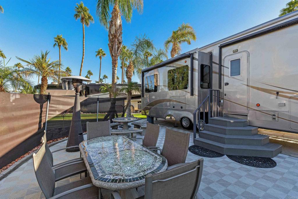 Lot 220, Spacious corner lot with expansive views! Lush gardens and grassy area to the street side and rear of this lot. A custom wind screen makes for comfortable sitting outside on breezy evenings. Outdoor Resort Palm Springs (ORPS) is a Guard Gated 5-Star RV Resort Community offering an active and luxurious lifestyle featuring golf (27 holes), tennis, pickleball, swimming and more! Two clubhouses, fitness center, beauty solan, La Roma Restaurant on campus, dog park and more!