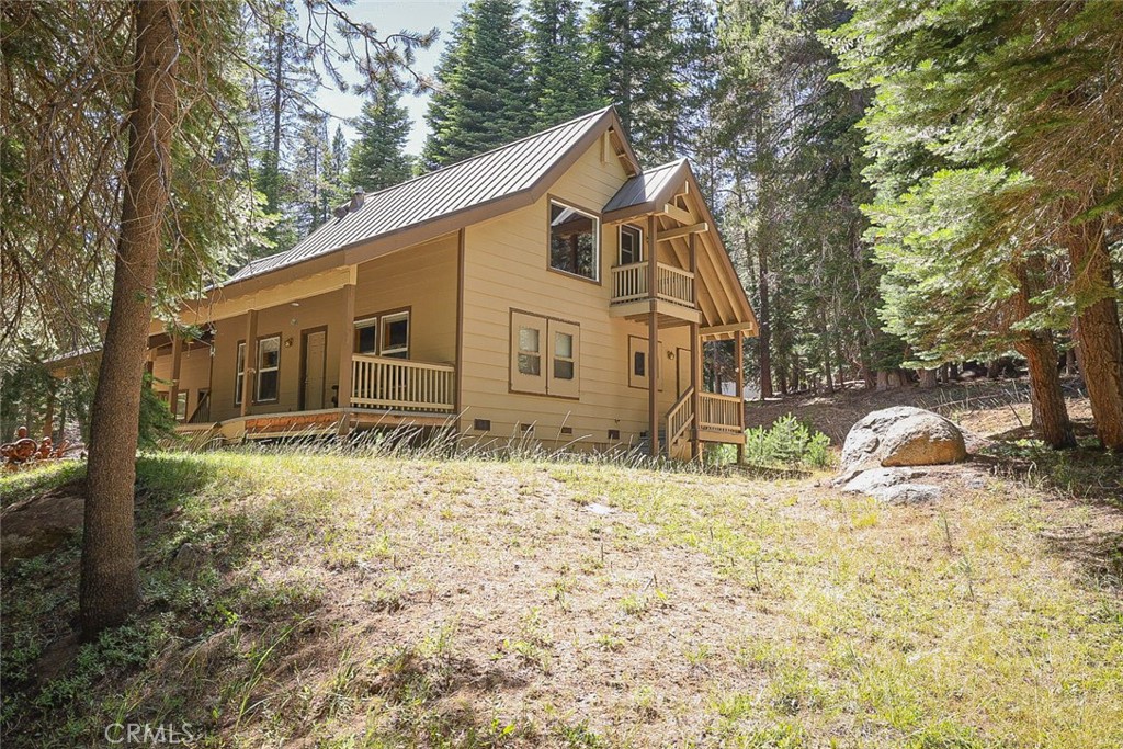 Surrounded by towering pines and bordering the National Forest, this 8.7-acre retreat offers the ultimate high-country escape. Tucked away in a peaceful, secluded setting, this cabin-style home showcases knotty pine cathedral ceilings, a cozy rock hearth with a Lopi woodstove, and an open loft that sleeps six. Enjoy complete off-grid living with an owned solar system, new battery bank, generator, and propane lighting backup. Outdoor enthusiasts will love the seasonal pond, meandering rock-lined pathways, and direct access to forest trails right from the property. There are 3 RV hookups with power and water, plus unique touches like an outdoor shower, sink, and rustic outhouse. A 2-car garage and covered walkway to the front deck make mountain living comfortable year-round. Seasonal access via paved road to a gated driveway ensures privacy and adventure in every season. Schedule your private tour today!