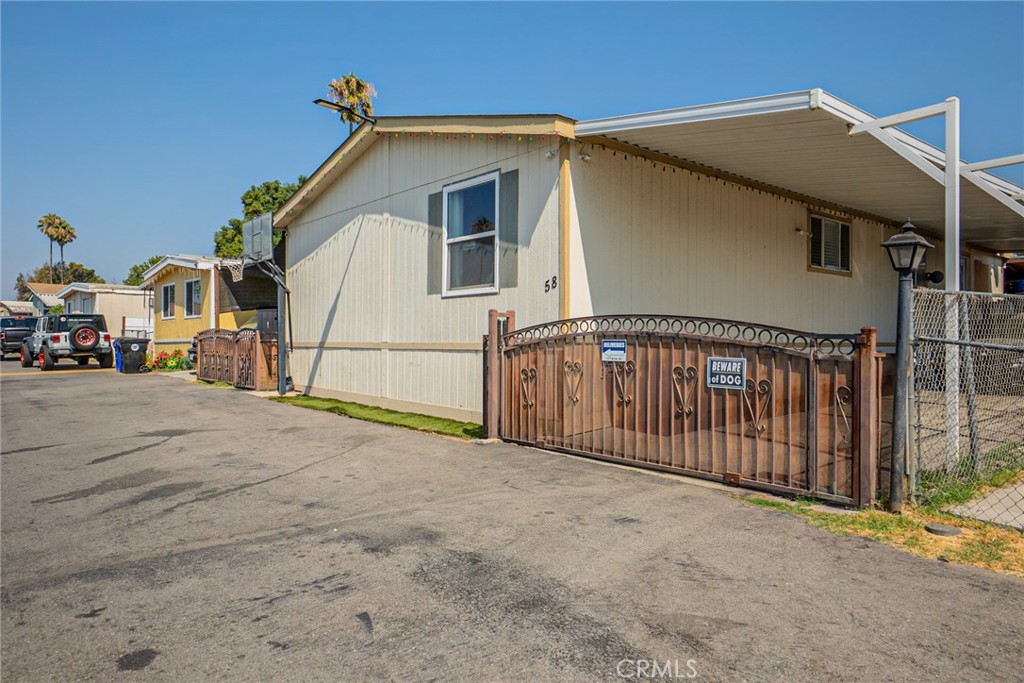 Discover this charming 3-bedroom, 2-bathroom manufactured home, a true gem nestled in the highly sought-after Cedar Village community in Bloomington. Step inside and be greeted by a spacious, light-filled living room, perfect for hosting gatherings and creating lasting memories. The home boasts a modern aesthetic with beautiful laminate flooring that extends throughout, complemented by upgraded bathrooms and a very updated kitchen area with laminate flooring. Enjoy year-round comfort with central A/C and heating. A dedicated laundry room adds to the home's convenience. Outside, the private backyard offers an ideal retreat for relaxation. Its prime location near the 10 freeway provides easy access to all the growing city has to offer, making this home a perfect blend of comfort, style, and convenience.