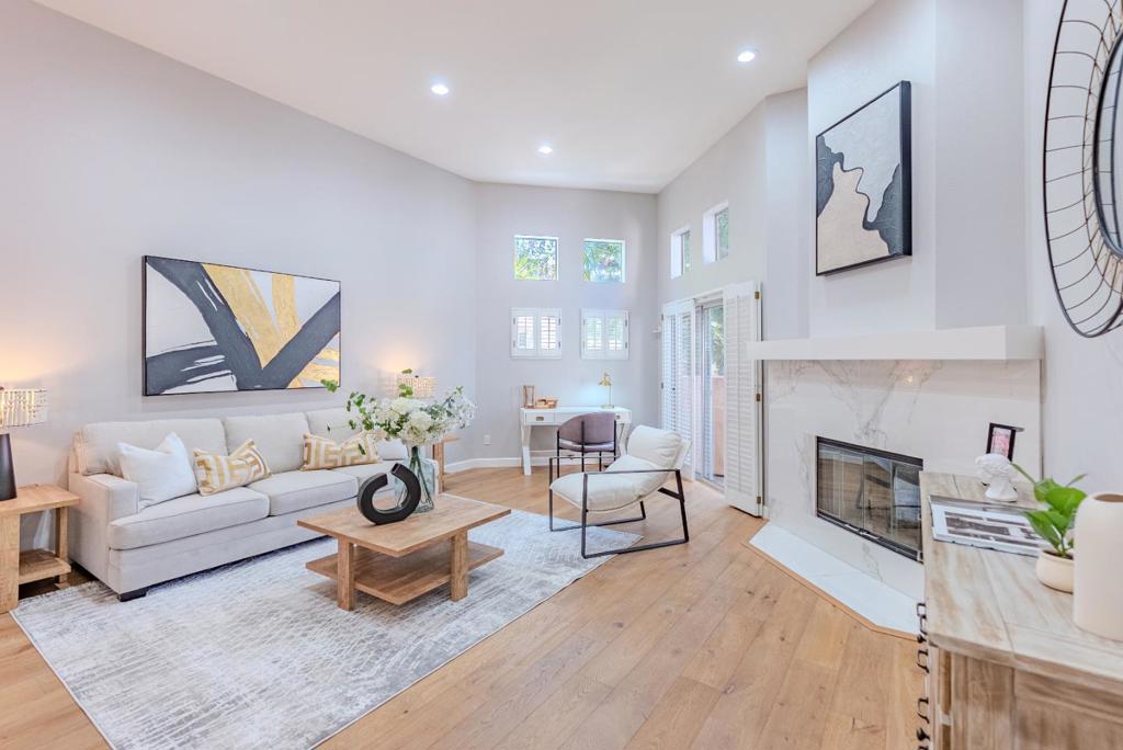 Perched in a serene gated community, this newly remodeled townhome boasts a unique loft-style design with soaring vaulted ceilings, dual-pane picturesque windows, and skylights. Located less than a mile from downtown Sunnyvale/Caltrain and minutes to downtown Mountain View, convenience meets style in this thoughtfully upgraded home. Inside, you'll find a blend of hardwood and carpet flooring, recessed lighting, new heat/AC, a cozy refinished gas fireplace and laundry closet with washer and dryer. The gourmet kitchen features high-end stainless steel appliances, stunning new backsplash, quartz countertops, ample cabinetry, pantry and breakfast bar. Luxury continues with two spacious bedroom suites, each with newly remodeled spa-like en-suite bathrooms. The primary suite includes a walk-in closet for added comfort. Additional highlights include a two-car garage with extra storage and EV hookup (220V), a relaxing private patio and multiple balconies. Community amenities include a swimming pool, spa, clubhouse and playground. With close proximity to parks, restaurants, shopping, golf courses and major tech giants like Google, Apple, and LinkedIn, as well as easy access to Highways 101, 85, 237, Central Expressway and VTA. Do not miss your chance to own this rarity. It will go FAST!