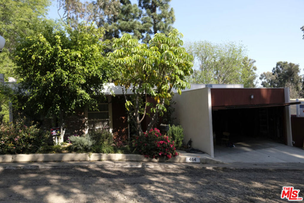 Architectural Kenter Canyon home impeccably maintained with over 2,600sf, 5 bedrooms, 3.5 baths. Mid-Century design, nicely scaled rooms with high ceilings, walls of glass sliders looking out to serene canyon views, accented by original wood detailing and fixtures. Remodeled kitchen and baths with updated systems. Main level has direct garage access, kitchen, breakfast, powder, living and dining rooms. Master bedroom suite with three additional bedrooms sharing one bath on lower level. Three of the four bedrooms have windows overlooking the canyon. Third floor is a large 5th bedroom overlooking canyon with private bath. Large decks off all three floors with stairs down to large flat grassy yard.