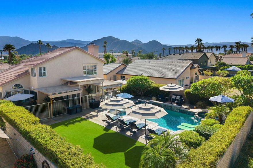 Welcome home to this inviting and beautifully updated 4 bedroom, 2.5 bathroom residence in the desirable Acacia at La Quinta community. Designed for effortless indoor/outdoor living, this furnished home offers stunning mountain views and a private backyard retreat complete with a sparkling pool and spa, lush green lawn, a built-in BBQ and pizza oven, and a large covered patio ideal for relaxing with friends.Inside, the remodeled kitchen features granite countertops, stainless steel appliances, and a charming greenhouse window that fills the space with natural light. An open living/dining area anchors the main level, while a private lounge off the kitchen showcases an upgraded fireplace, wet bar, and wine storage -- a perfect space to gather and unwind.The primary suite includes a double vanity and walk-in closet, while three additional bedrooms provide flexibility for guests, a home office, or hobbies. Additional features include an automated lighting system, updated guest bathrooms, and plantation shutters throughout.With no HOA fees and just minutes from world-class golf, tennis, pickleball, hiking, dining, shopping, and Acrisure Arena events, this Acacia at La Quinta home delivers the quintessential desert lifestyle.
