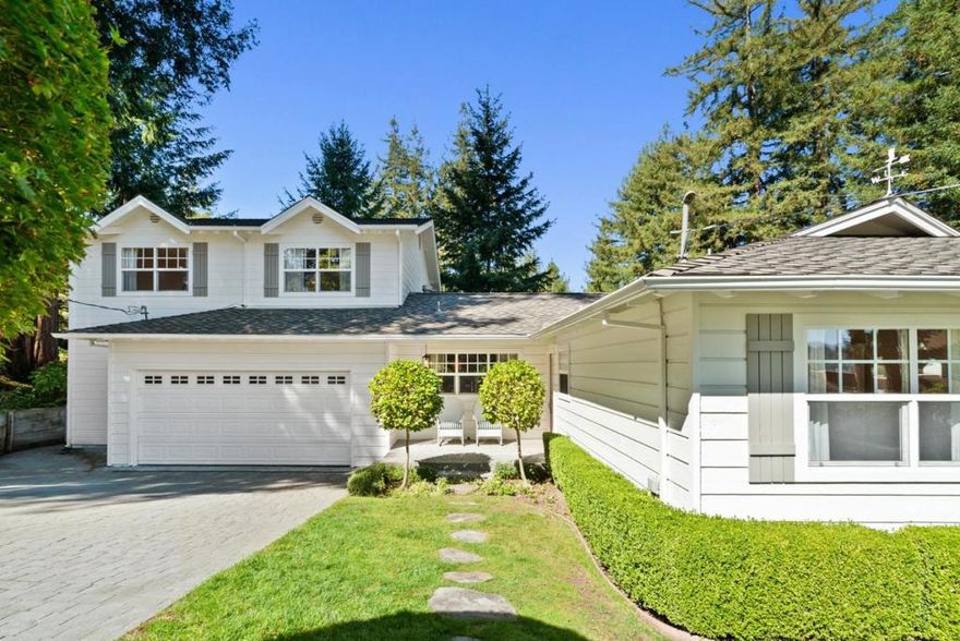 Nestled on a sunny, private half-acre lot in an enchanting redwood setting sits this immaculate 4 bedroom, 3 bathroom home with a resort-style back yard. The open-concept floor plan centers around a gorgeous chef's kitchen & a spacious dining room. The kitchen boasts custom cabinetry, granite countertops, a farmhouse sink & high-end SS appliances, including a stunning 6-burner 48-inch Viking range. The living room boasts sweeping mountain views & a cozy Waterford gas stove. The home seamlessly integrates with nature, featuring walls of windows and multiple doors that open to the wraparound deck. Two bedrooms & full baths (including the primary suite) are located on the ground level. Upstairs, you'll find two more bedrooms, a full bathroom & a loft. Tasteful finishes include maple hardwood floors, Emtek crystal door hardware, vintage-inspired lighting & plumbing fixtures & an adorable Dutch door. The oversized 2-car garage provides ample room for a workshop or hobby space. Additional amenities include dual-zone heating, air conditioning, water softener & central vacuum. The yard is beautifully landscaped with lawn, privacy hedges & a variety of flowering plants. Walking distance to award-winning SV schools, hiking trails & more. Turns out, you really can have it all!