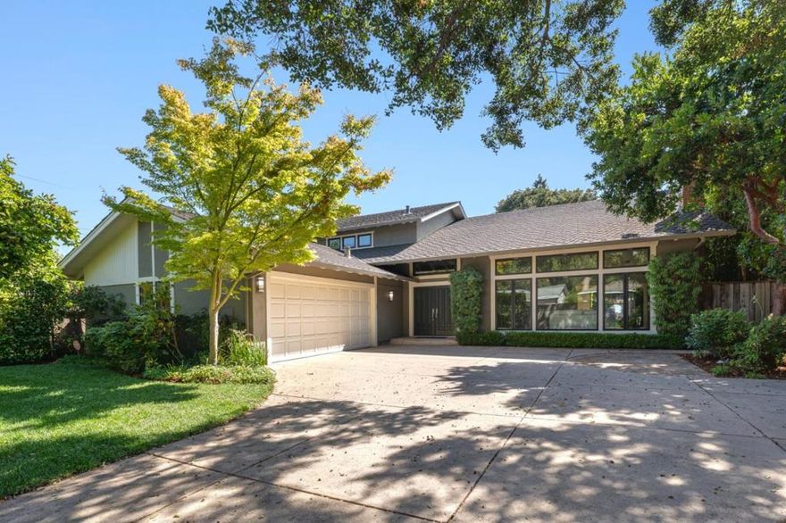 Estate-caliber living with signature Hillsborough elegance unfolds in this rare contemporary 5BR/3.5BA residence just moments from downtown San Mateo. Secluded beyond a stately hedge and a prestigious gated entrance, the grounds are enveloped in lush, mature landscaping that creates an atmosphere of unrivaled privacy. Elevated ceilings, oak flooring, expansive walls of glass, built-ins, and distinct architectural details enhance the aesthetic. A dramatic foyer introduces distinguished interiors where formal living and dining rooms flow effortlessly into open-concept casual spaces, ideal for both entertaining and comfortable day-to-day living. The chefs kitchen is a showpiece, appointed with premium appliances, custom cabinetry, sleek stone surfaces, and designer finishes, all overlooking the inviting family room and beautifully manicured rear yard. Completing the main level is a versatile bedroom or office, a half bath, a well-equipped laundry room, and an impressive custom wine fridge. Upstairs, the vaulted-ceiling primary suite is a private retreat with a sublime ensuite bath, offering a haven from the everyday. A second ensuite bedroom, two additional bedrooms, and a hall bathroom round out the upper level. Primely located near shopping, dining, Caltrain, and conveniences!