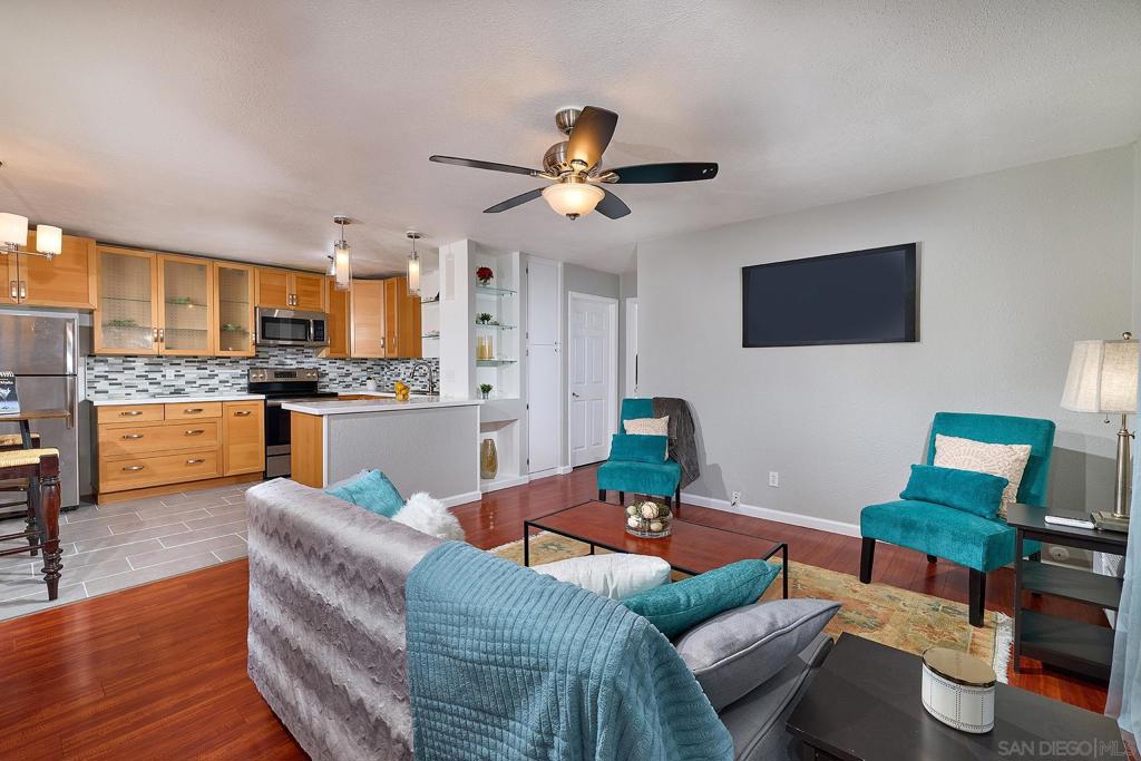 FHA & VA approved. Recently remodeled and centrally located, this condo features custom cabinetry, a glass tile backsplash, and matching stainless steel appliances. Wood flooring flows throughout the living areas, with new tile in the kitchen and bathroom floors. Both bedrooms are generously sized—each fits a king-size bed with room for two nightstands—and include large closets. The hallway offers additional storage with custom shelving and a linen closet. A sliding door in the family room opens to a private patio just steps from the community pool and jacuzzi. Enjoy the convenience of community laundry facilities and an assigned, covered parking space (#23) just outside the front door, plus a permitted additional space. Located in the desirable Friars Pointe community, you're minutes from SDSU, golf courses, shopping, dining, and have easy access to major freeways and the nearby Trolley station—less than a mile away.