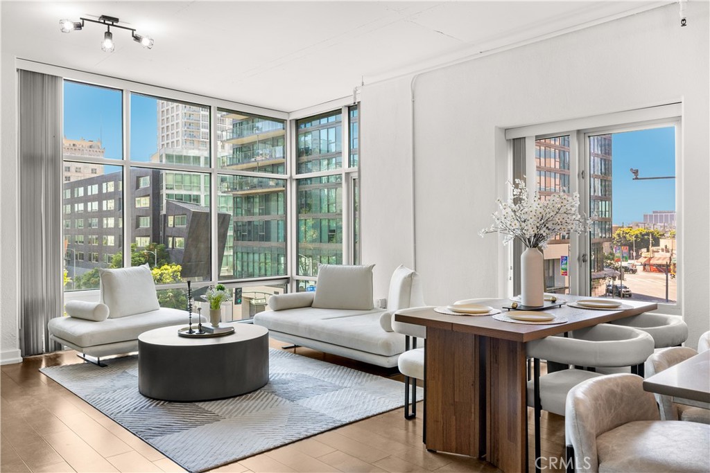 This amazing rare corner residence offers expansive southwest-facing floor-to-ceiling windows that flood the home with natural light. The elegant interior features wide-plank hardwood flooring throughout, an open-concept layout, and a sleek kitchen appointed with Ceaserstone quartz countertops, a Whirlpool five-burner gas range, stainless steel appliances, and in-unit washer/dryer. Two generously sized, gated side-by-side parking spaces are included.
Market Lofts provides 24-hour concierge service, ensuring security and seamless package and delivery management. Amenities include a resort-style pool, 20-seat private screening room, fitness center, clubhouse, and BBQ area.
Ground-level conveniences include Ralph’s, Coffee Bean, and more. Ideally located within walking distance to Whole Foods, LA Live, The Bloc, fine dining, and upscale retail.
Experience refined urban living in the heart of Downtown LA.