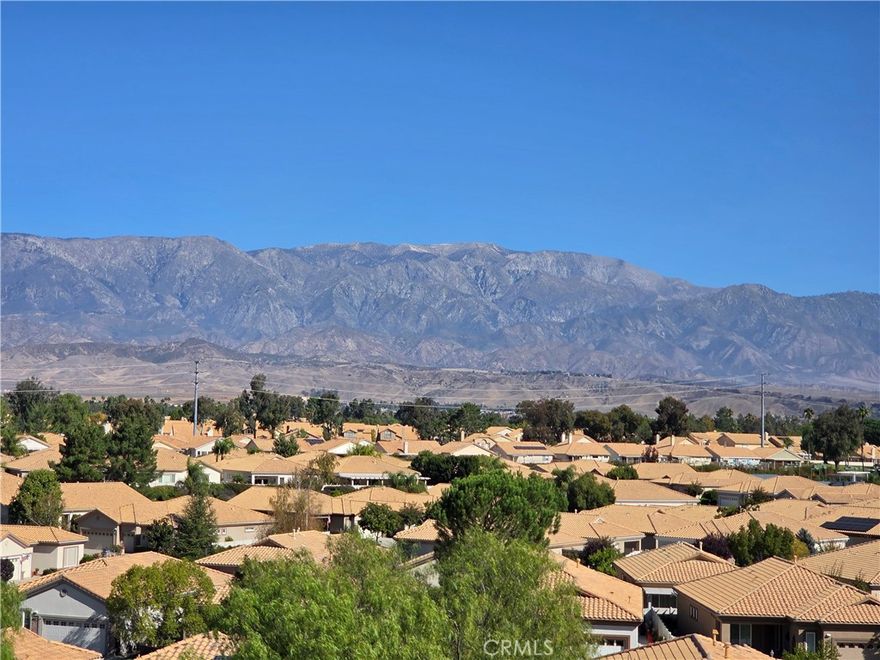 FABULOUS PANORAMIC VIEWS of MOUNTAINS & LIGHTS AT NIGHT from this Upgraded Trillion (2 BR, 2 BA + Den - 1,683 Sq. Ft).   Features with this well-maintained home include: Two Bedrooms, thoughtfully located on opposite sides of the home, both with walk in closets (Master Closet is HUGE) and adjoining bathrooms; Great Room Concept, offering Wonderful Natural Light Flow and Views from Several Rooms; Neutral Laminate Flooring; Added and Enhanced Kitchen Cabinetry with Glass insets & Lighting; Almost new SS Appliances - Refrigerator, and Washer & Dryer will be included in the price (white Washer & Dryer); Cozy Fireplace; and Laundry Room with Storage and Utility sink.  Enjoy indoor/outdoor living with a Covered Patio - Landscape (Front, Back & Sides) have been completely Redone and is Gorgeous - Vibrant Colorful Landscape and even has an English Garden - Two Avocado & One Lemon Tree - Beautiful Yard Areas with Stunning Views ....... Sun Lakes Country Club goes beyond just a place to live - It's a vibrant community designed to keep you Active & Engaged, offering: TWO 18-HOLE GOLF COURSES with 2 Pro Shops, THREE Clubhouses, TWO Restaurants, Bar & Lounge, Tennis, PICKLE BALL COURTS, Pools (Including Large Indoor Pool), Jacuzzi Spas, THREE Fitness Centers & Fabulous Planned Activities Offered on a Daily Basis. There are 80+ Social CLUBS, including: Dancing, RV Club, Yoga, Table Tennis, Cards, Bocce Ball, Bowling, Car Club, Drama/Theatre Club, Sewing, Tennis, Knitting, Bingo, Travel, Quilters, Art League, International Culture, Genealogical Society, Garden, Photography, Travel, and a lot MORE .... If that's not Enough, Add TRIPS AND TRAVEL EXCURSIONS scheduled all year long. Association Dues INCLUDE CABLE TV & INTERNET - The community is Located Close to Casinos, World Famous Shopping (Cabazon and Palm Springs), Restaurants, and Excellent Medical Facilities - SUN LAKES COUNTRY CLUB is has a backdrop of two Mountain ranges, which offer stunning views - LIFE IS GOOD in our Awesome Community!