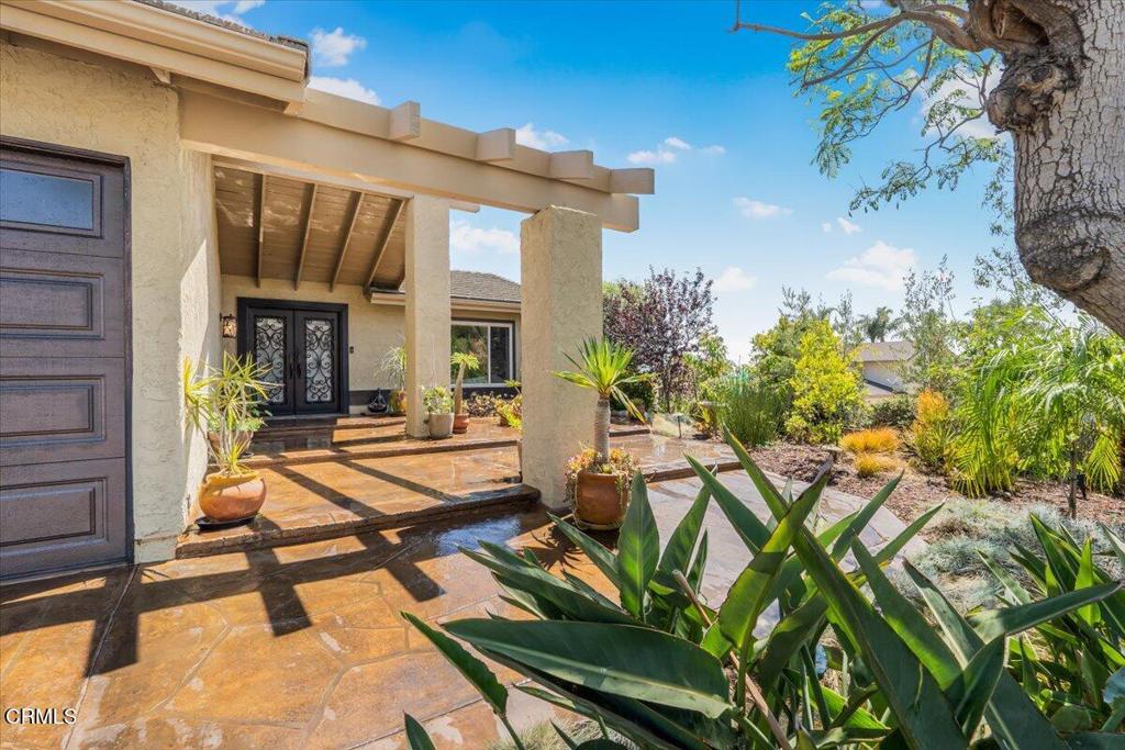 Nestled at the top of a serene cul-de-sac on a raised corner lot, this elegantly upgraded 4-bedroom, 3-bathroom home offers over 2,200 sq ft of luxurious living space with sweeping mountain and distant ocean horizon views.Step inside through a custom-designed front door and onto rich bamboo floors, where soaring ceilings and expansive windows bathe the home in natural light. Custom window treatments and premium finishes add layers of refinement throughout.The open-concept layout is anchored by a spacious family room, creating an inviting atmosphere for both entertaining and everyday living. The chef-inspired kitchen features striking Calacatta gold quartz countertops, premium stainless steel appliances, refinished cabinetry with deep self-closing drawers, and abundant, thoughtfully designed storage.A guest bedroom on the main level sits adjacent to a tastefully remodeled full bath with limestone flooring--ideal for visitors or multi-generational living.Upstairs, the luxurious primary suite is a private sanctuary featuring a cozy fireplace, a personal balcony perfect for sunsets and moonlit nights, and a spa-inspired ensuite bath with a steam shower. Two additional upstairs bedrooms also offer direct access to the spacious Trex deck, where panoramic views of the mountains, city lights, and ocean horizon await.The expansive backyard is an oasis with a lush green privacy fence, a large flagstone patio, and a built-in BBQ island with a large sink and cooler-- designed for both relaxation and entertaining. Enjoy the abundance of nature with over a dozen mature, fruit-bearing trees--including avocado, mango, citrus, fig, pear, peach, and even a flourishing grapevine - providing your very own organic garden-to-table experience.Additional highlights include an oversized 3-car garage, tankless Noritz water heater, and washer/dryer hookups.This Camarillo Heights turnkey gem offers a rare blend of refined upgrades, tranquil privacy, and everyday luxury. This home is truly one-of-a-kind-- inviting you to enjoy the seamless blend of comfort and the California lifestyle.