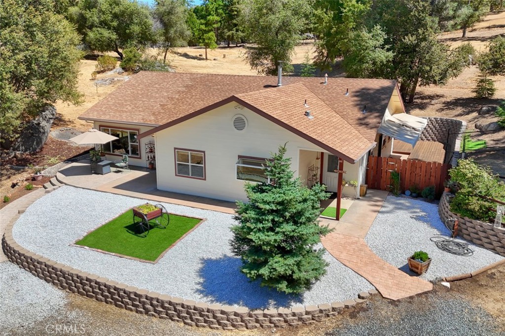 Turnkey Foothill Property with Shop, Wells & Pastures! Built just 11 years ago, this 2,046 sq. ft., 3-bedroom, 2-bath home sits on 6.22 all-usable acres designed for both comfort and independence. The open floor plan connects the living room, family room, and gourmet kitchen, all filled with natural light. Highlights include a 100 GPM well plus backup well, on-demand generator, wood stove, central heat/air, and an 840 sq. ft. shop with loft and roll-up door. The property is fully fenced and cross-fenced with two pastures, a no-climb fenced backyard, three outbuildings, and fresh updates including laminate flooring, redwood decking, and new interior/exterior paint.
Enjoy the freedom of wide-open space with the convenience of paved, all-weather access. Yosemite National Park is just 45 minutes away via the scenic Merced River corridor, offering endless opportunities for outdoor adventure. Whether you’re seeking a retirement retreat, hobby farm, or property already set up for country living, this home is ready from day one.