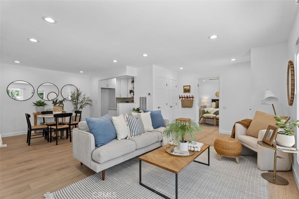 Completely Remodeled Single-Level Stunner in Aliso Meadows! Welcome to the largest and most beautifully remodeled floor plan in the Aliso Meadows community of Laguna Hills—a true showstopper, rebuilt from the studs up with nearly everything brand new! This immaculate 3-bedroom, 2-bathroom attached home offers the rare blend of luxury, convenience, and single-level living—perfect for first-time buyers, downsizers, or growing families. Step inside and be wowed as natural light pours through multiple windows, dancing across the gorgeous new white oak luxury vinyl flooring and freshly finished walls. The expansive family room is anchored by a large sliding glass door leading to your private patio, and includes a versatile nook—ideal for a home office, reading area, or play space. The adjacent dining area flows seamlessly into a dream kitchen, showcasing brand-new white shaker cabinetry, elegant quartzite countertops, a deep modern sink, and sleek stainless steel appliances. Every finish has been hand-selected for both style and function—this is the kitchen you’ve been waiting for! Tucked away for privacy, the primary suite is a true retreat with its own slider to the patio, dual mirrored closets, an attractive ceiling fan, and a spa-like ensuite featuring a white vanity with marbled quartzite, brushed steel finishes, frameless glass shower, and a private toilet space. The two secondary bedrooms, beautifully designed with mirrored closets and ceiling fans, share a remodeled bathroom with designer details—including quartzite counters, shaker cabinetry, and frameless glass doors. Convenient in-unit laundry and ample storage make everyday living effortless. Step outside to your extra-long, private vinyl-fenced patio, accessed from both the family room and primary suite. With mature fruit trees, it’s a peaceful sanctuary perfect for BBQs, morning coffee, or evenings with friends and family. And this home isn’t just a pretty face—it’s all-new under the hood: new HVAC ducting, AC, furnace, water heater, PEX piping, electrical panel, and subfloor. Set in a quiet community just steps from the Aliso Creek Trail, parks, top-rated schools, community center, shopping, and dining. Minutes to world-class beaches and major freeways. This is more than a remodel—it’s a full transformation. Come fall in love—homes like this don’t come around often!