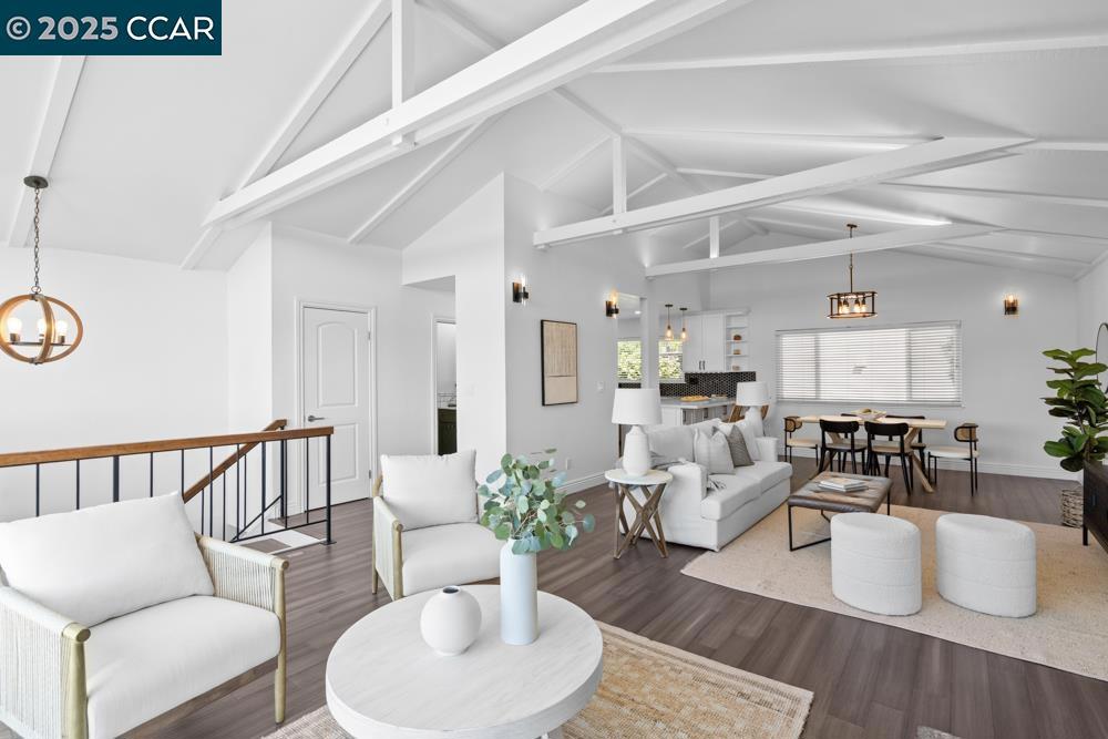 Welcome to your slice of coastal living. This light-filled townhouse-style condo combines the comfort of a single-family home with the ease of a boutique 8-unit community. Tucked at the end of a quiet cul-de-sac, you’re minutes from beaches, parks, shops, and the ferry. The main living area is designed for gathering, with vaulted ceilings, expansive windows, and a cozy gas fireplace and bamboo hardwood flooring throughout. The open kitchen blends style and function with quartz countertops, shaker cabinetry, stainless steel appliances, and a spacious pantry. Upstairs, a generous deck invites you to relax while enjoying views of the lagoon and swaying palms. Downstairs, two bedrooms each offer ensuite baths and private outdoor access, with the primary suite opening directly to a tranquil patio. Updated baths and abundant storage make everyday living easy. An attached two-car garage with a versatile walk-in workspace adds even more flexibility. Just steps from a private dock with lagoon access, this home is the perfect balance of coastal charm and modern convenience. Washington Park, Maya Lin Elementary, Webster Street dining, Crown Beach, and the Farmers Market are all just around the corner, with easy access for commuters.